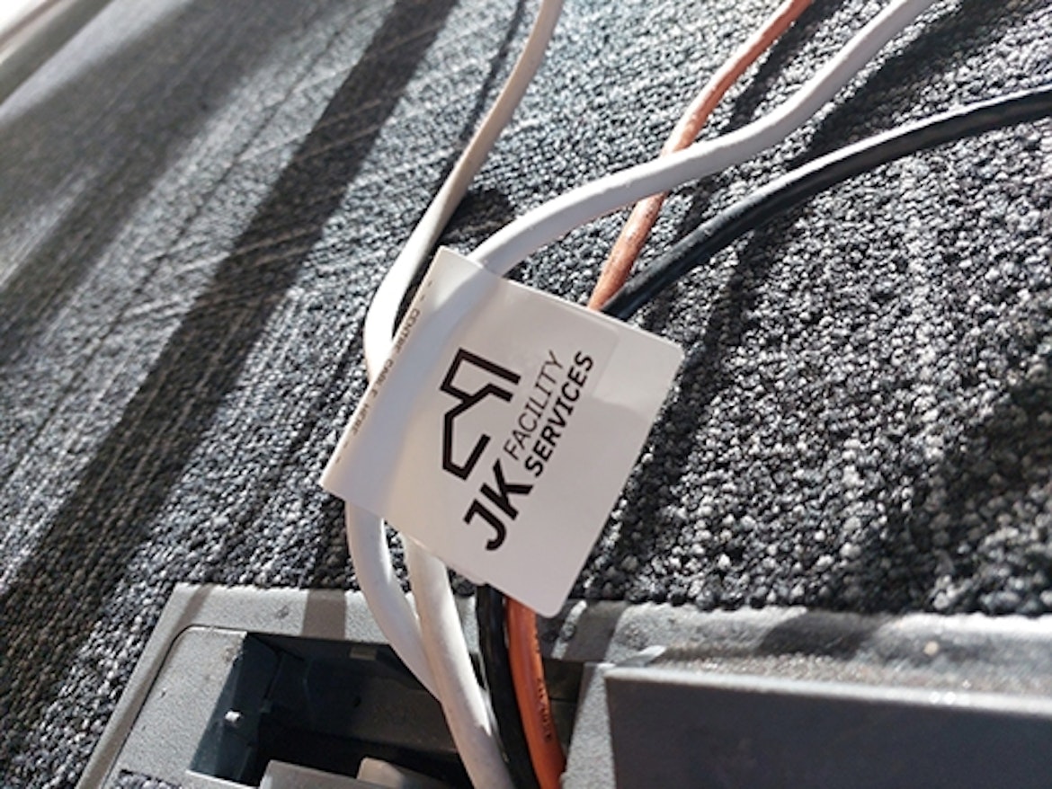 A test and tag label on an electrical chord in an office